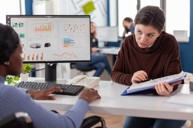 Businesswomen strategizing financial plans together