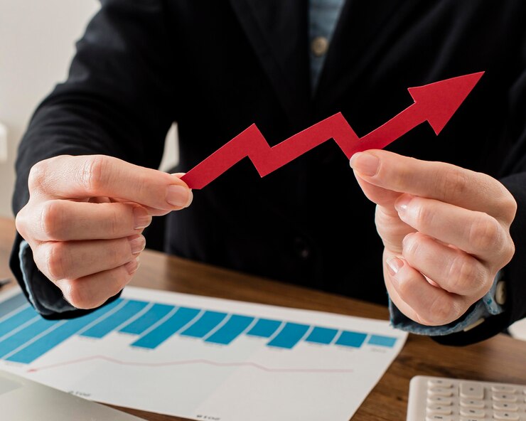 Businessman analyzing sales growth with arrow chart