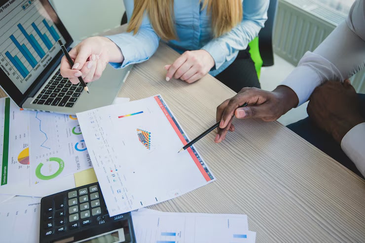 Employees reviewing revenue analysis and reports