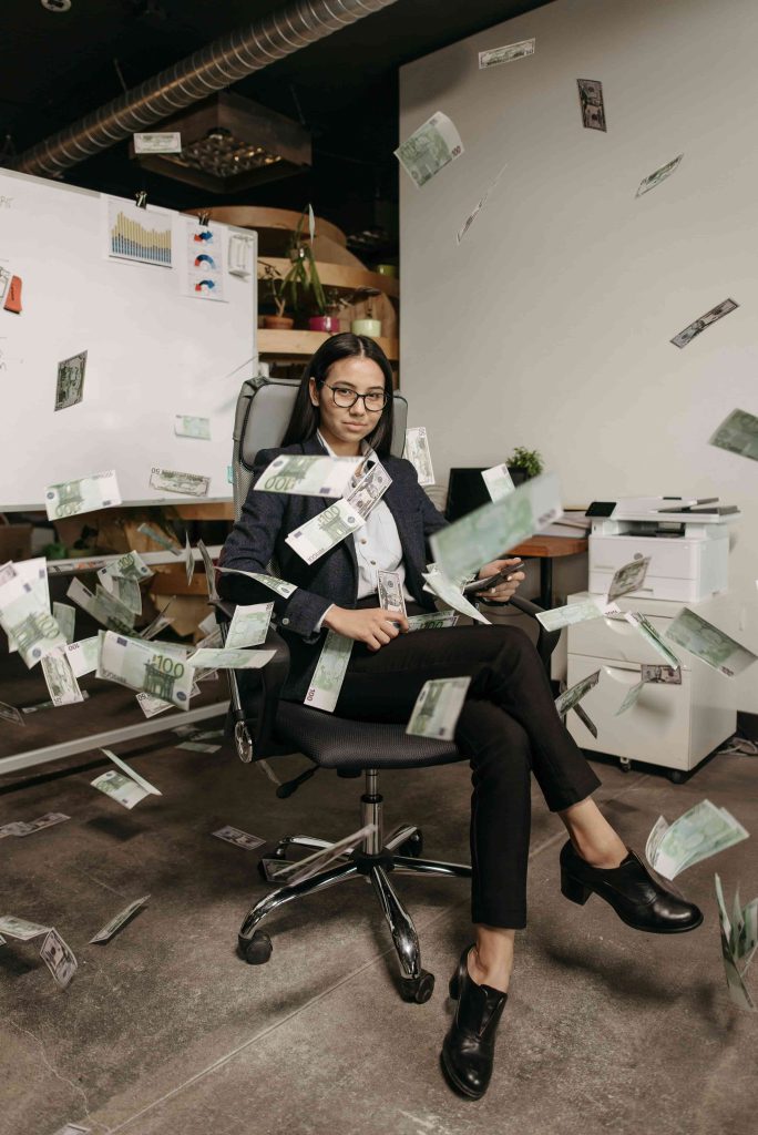 Boss lady seated with money, planning