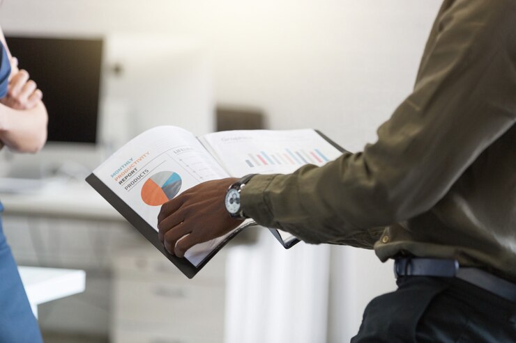 Man reviewing sales document during discussion